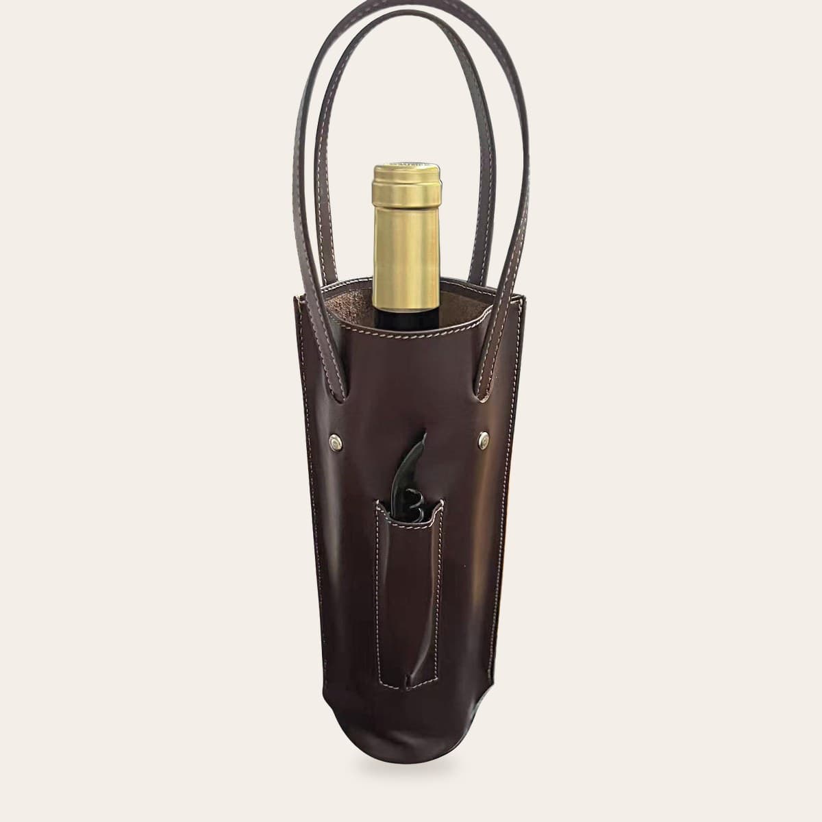 Dark brown leather wine carrier with two stitched handles, a bottle inside and a corkscrew in the front pocket