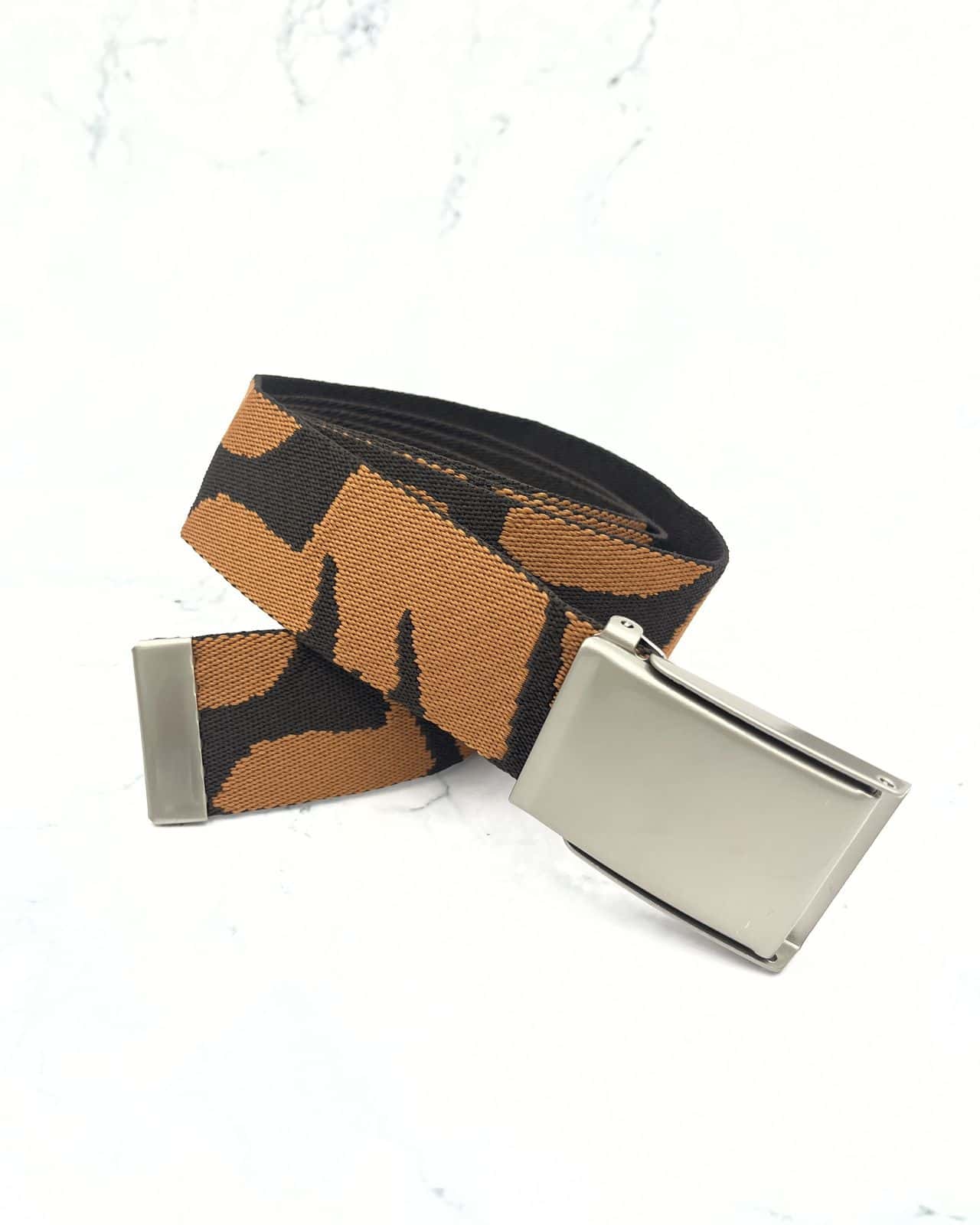 A brown-and-black jacquard webbing belt with a matte clip buckle