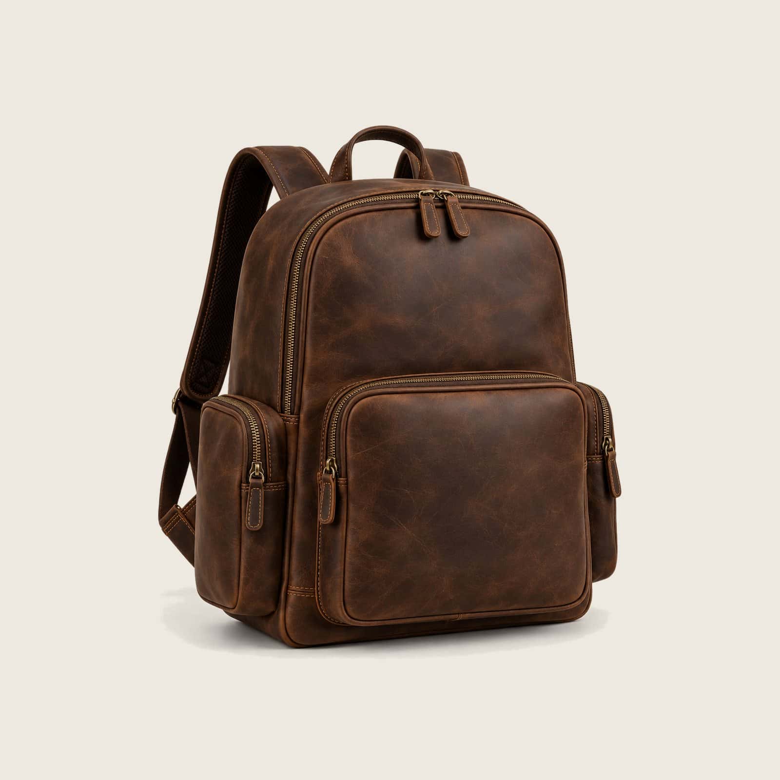 Brown crazy-horse leather backpack with a large zipped front pocket and zipped side pockets