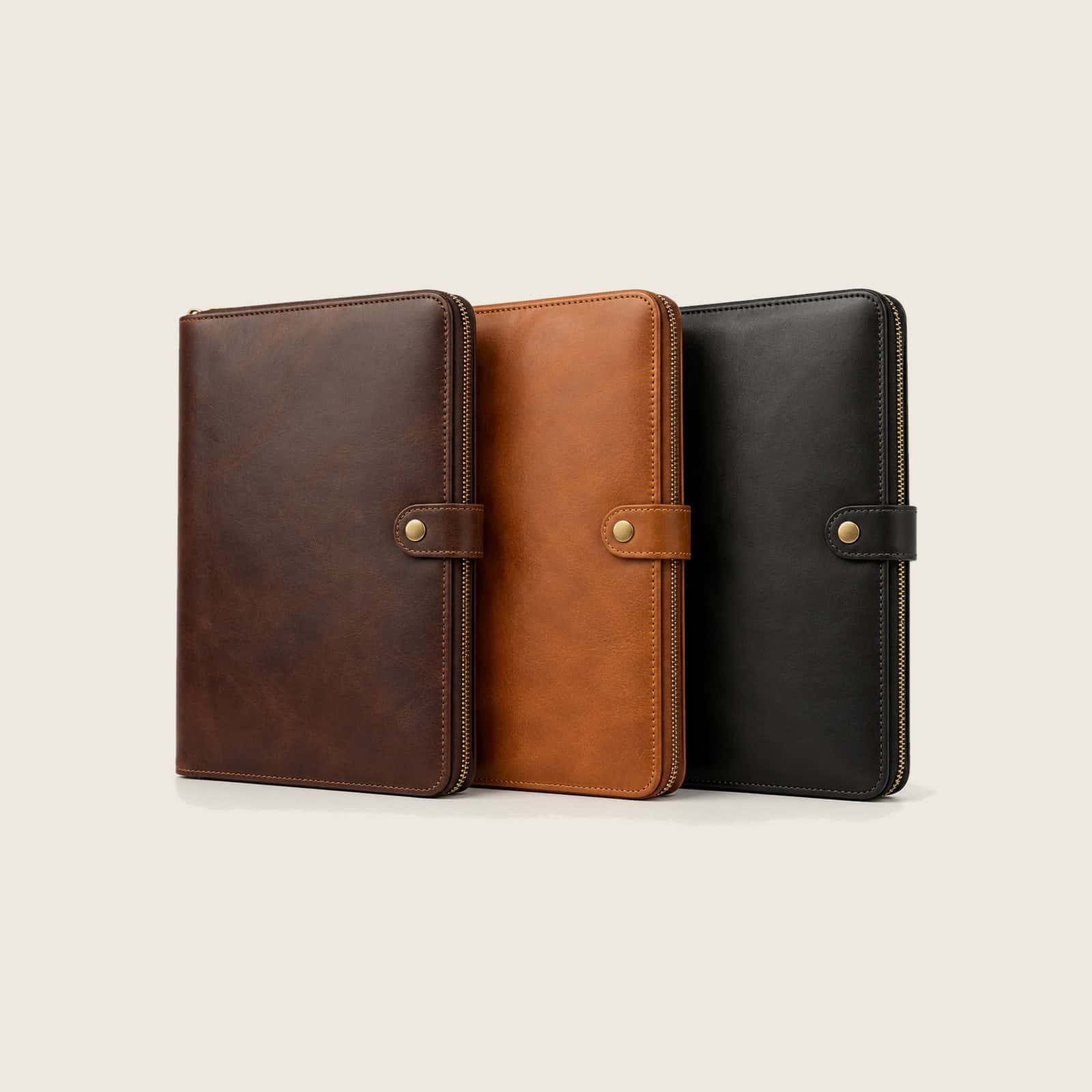 Zip-around leather organizer folders in dark brown, tan and black, side by side