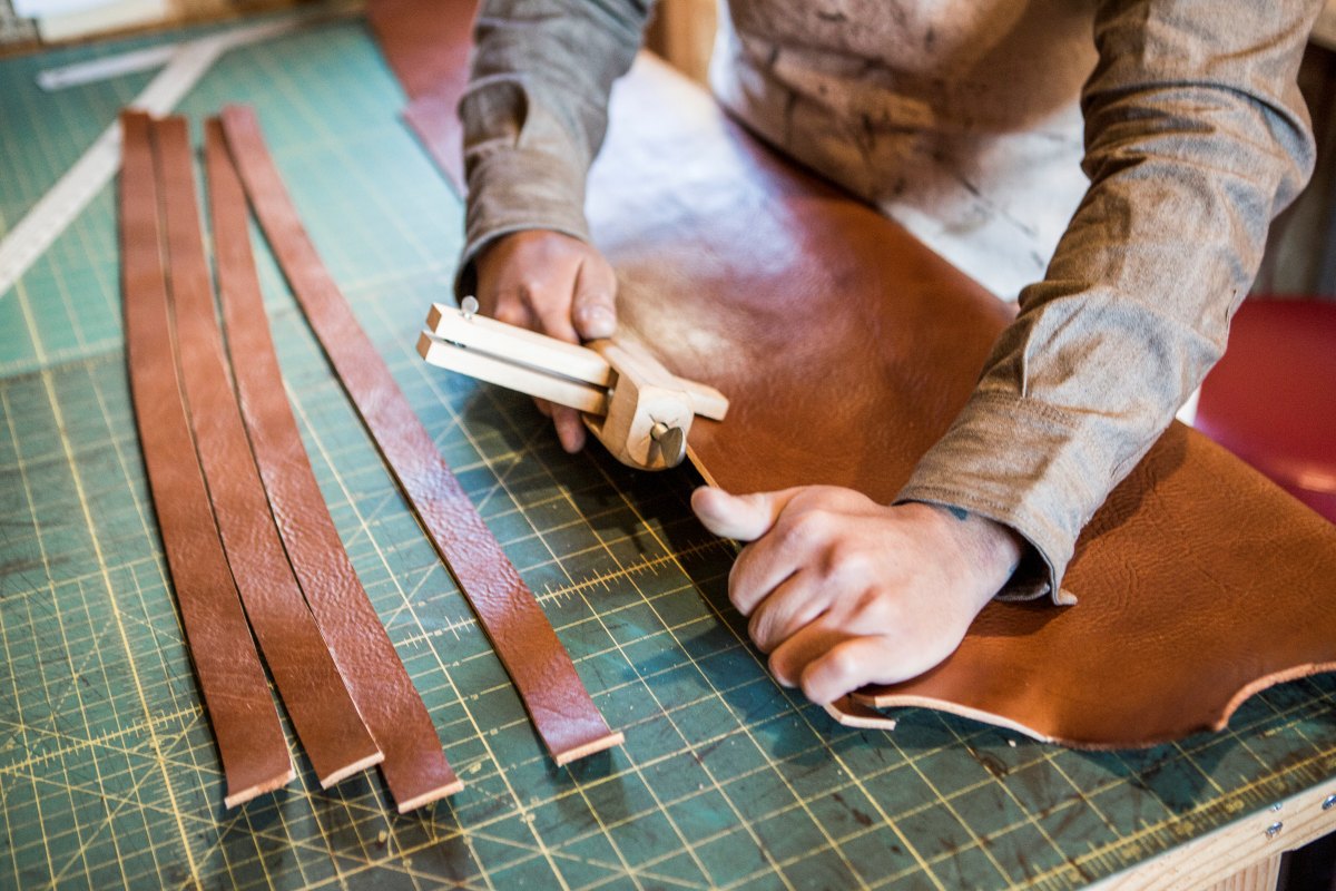 Craftsperson Meticulously Tools A Leather Belt Wit 2024 07 11 20 21 29 Utc